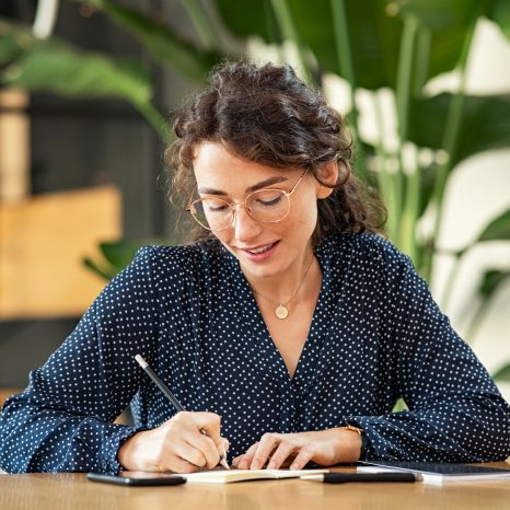 A woman at her desk exploring self-employed health insurance options.