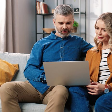 Couple looking through and comparing their health insurance options.