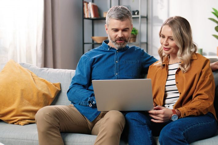 Couple looking through and comparing their health insurance options.