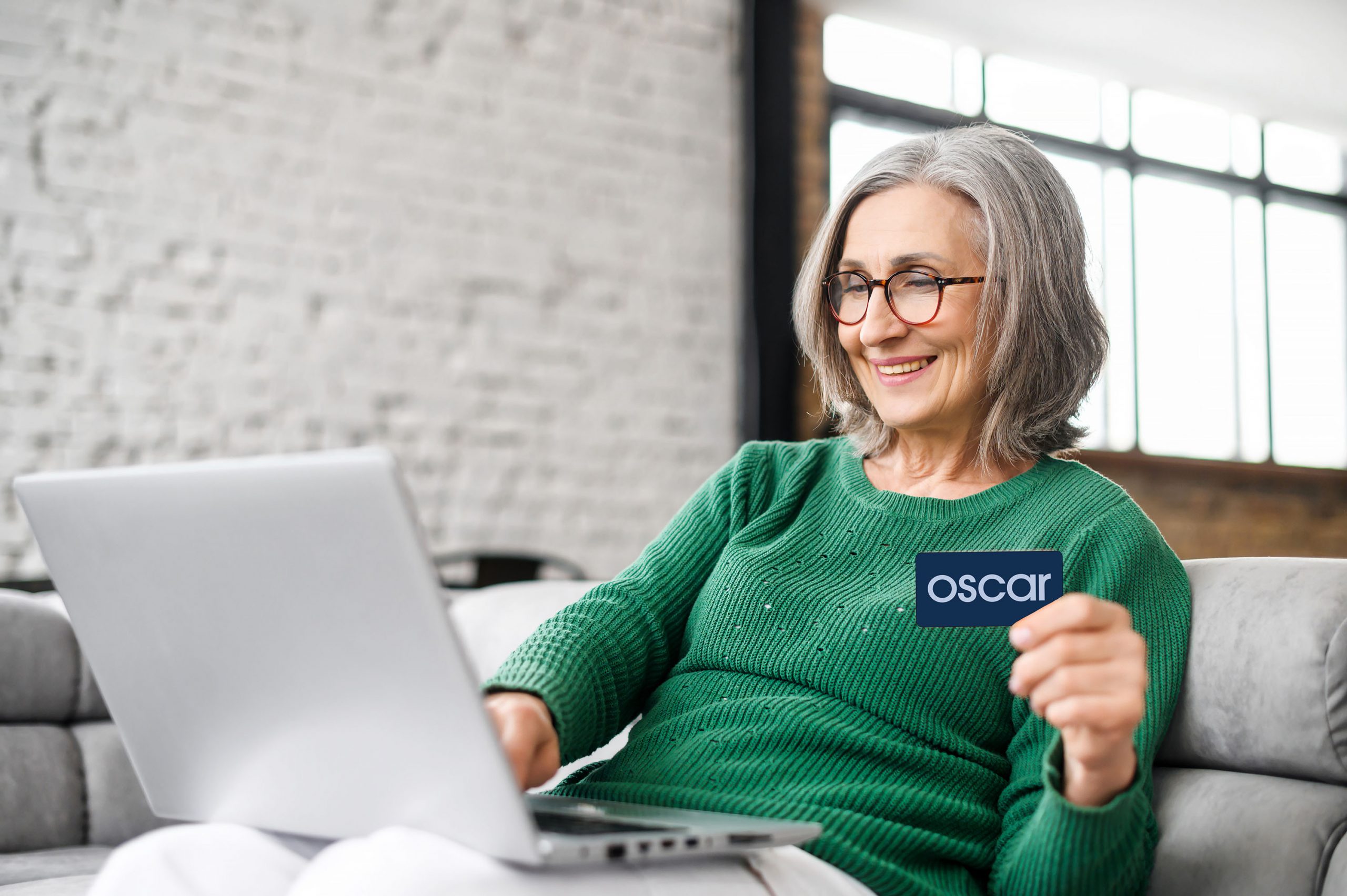 Pretty Senior Businesswoman In Glasses And Green Jumper Sitting
