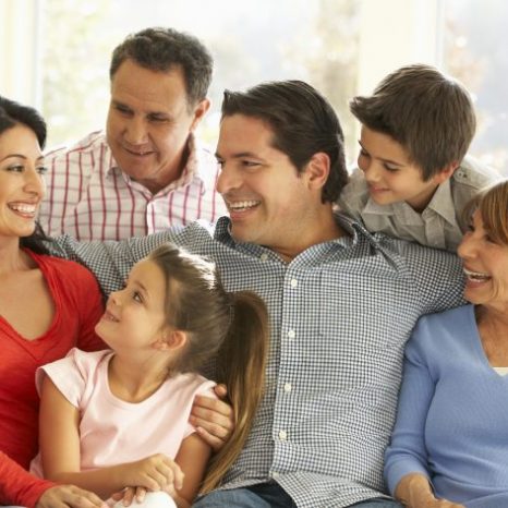 A family sitting together and smiling.