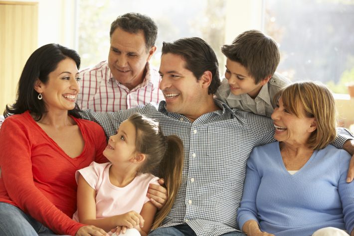 A family sitting together and smiling.