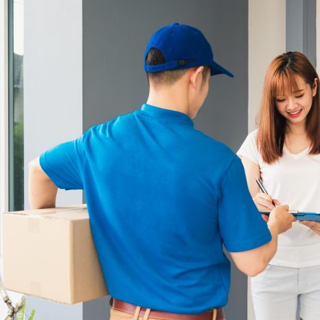 Asian Beautiful Customer Young Woman Signing Delivery In Clipboa
