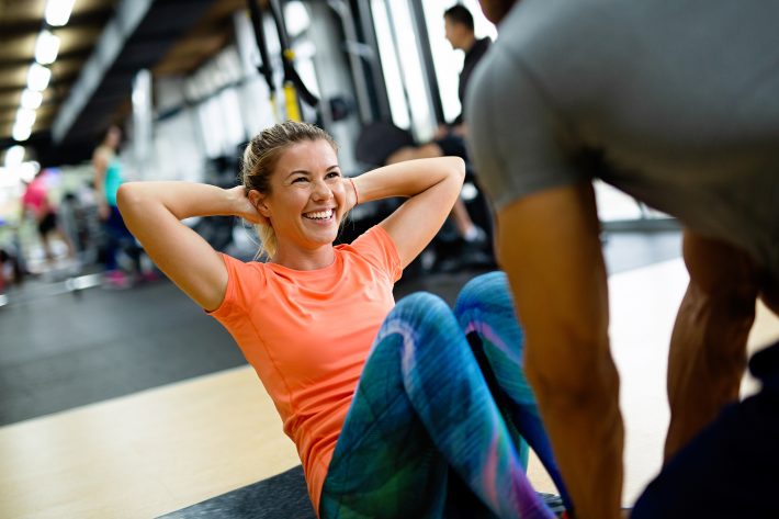 Fit Happy Woman With Her Personal Fitness Trainer In The Gym Exe