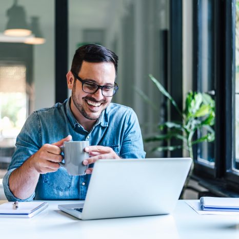 Happy Male Professional Having Coffee. Young Smiling Businessman