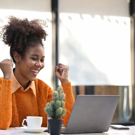 Excited African American Woman Reading Email With Good News On L