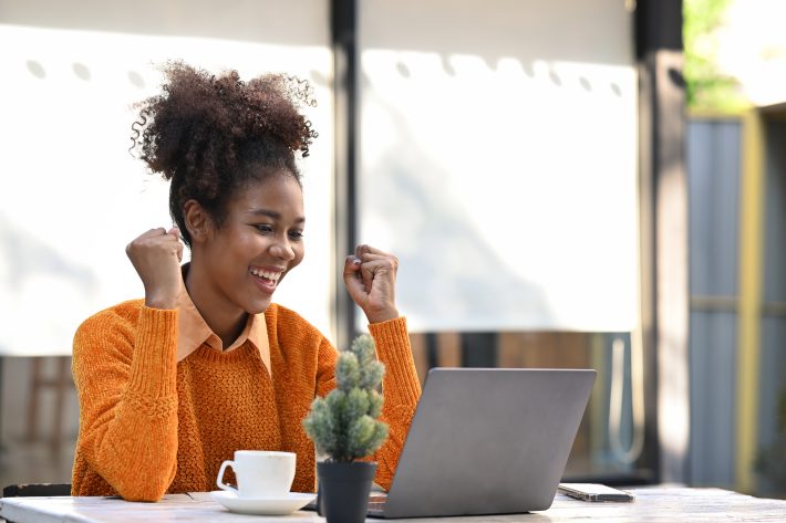 Excited African American Woman Reading Email With Good News On L