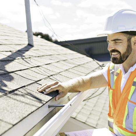 Man In A Hard Hat, Holding A Clipboard, Standing On The Steps Of
