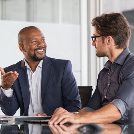 Two happy business colleagues at meeting in modern office interi